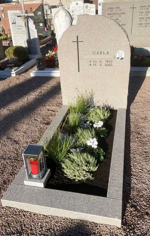 Einzelgrabstein aus Porphyr mit kleinem Bronzekreuz