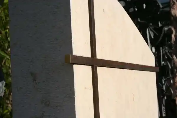 Kreuz aus Bronze in den Grabstein vertieft